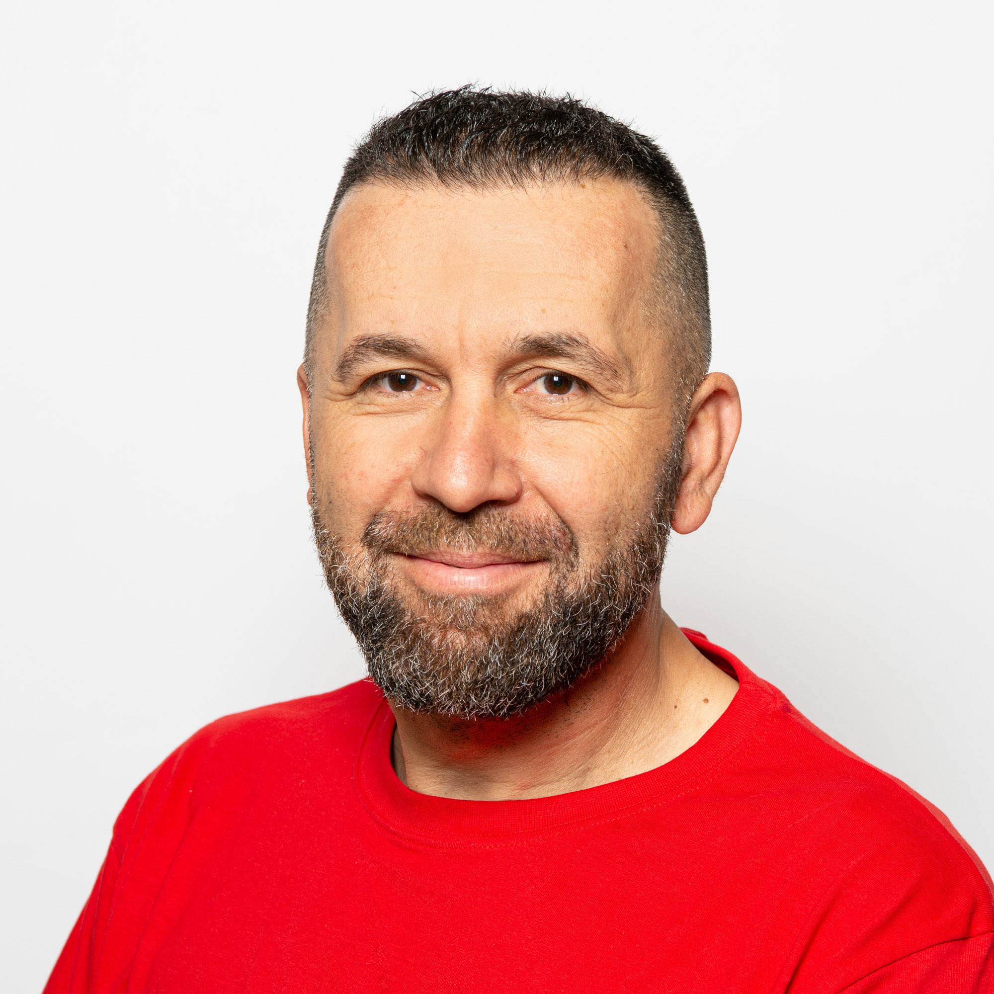 Portrait Mitarbeiter Elektro Egli AG Ibraimi Azbi im roten T-Shirt